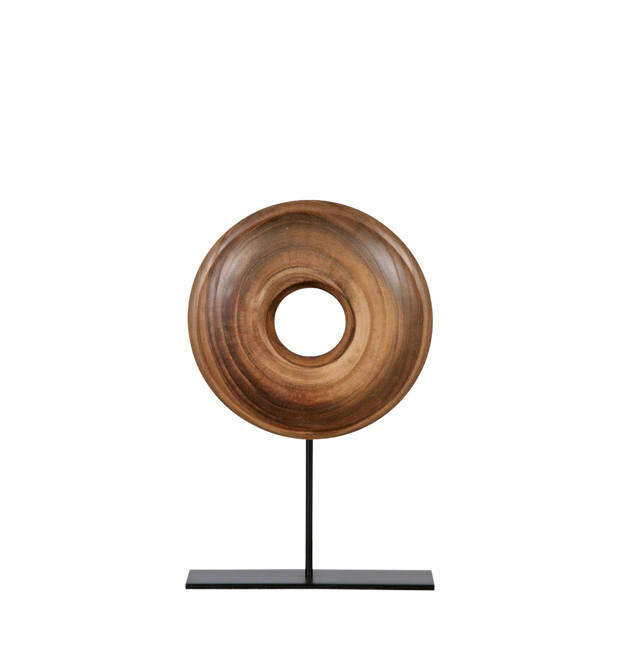 Wooden ring sculpture on a black stand.