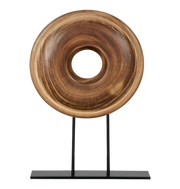 Wooden ring sculpture on a black stand.