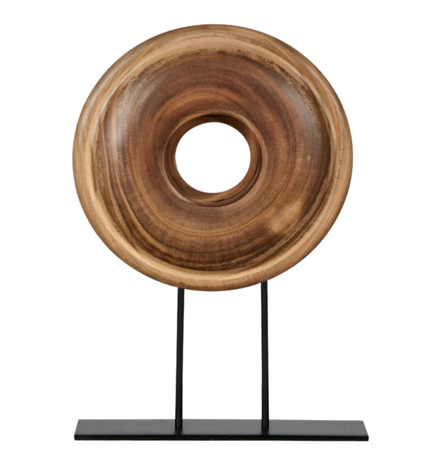 Wooden ring sculpture on a black stand.