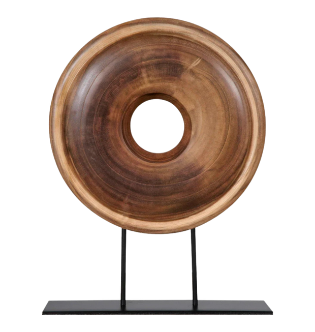 Wooden ring sculpture on a black stand.
