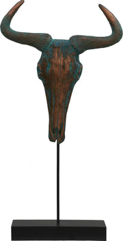 Decorative bull skull sculpture on a stand with a white background