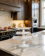 Modern kitchen with marble countertop, stainless steel appliances, and wooden cabinets.