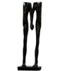 Black sculpture of legs on a white background