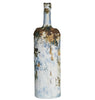 Decorative bottle with a textured, multicolored surface on a white background