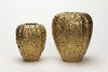 Two textured gold vases on a white background