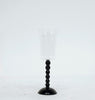 Black candle holder with a white candle on a white background