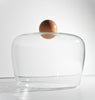 Clear glass container with a wooden lid on a white background