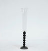 Clear vase with black base on a white background
