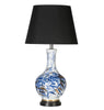 Table lamp with a black shade and blue and white abstract design on the base.