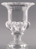 Clear glass urn with decorative design on a gray background