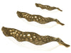Three golden elliptical leaf-shaped ceramic plates in different sizes with a textured surface and a shiny finish.